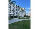 Exterior view of the condo building showcasing well-maintained grounds, sidewalks, and black railed balconies at 4024 Breakview Dr # 10804, Orlando, FL 32819