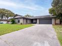 Single-story home featuring a well-kept lawn and a spacious two-car garage at 412 Parson Brown Way, Longwood, FL 32750