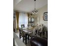 Elegant dining room showcasing a chandelier, a large window and a dining set for six at 4411 Hazelton Ct, Orlando, FL 32818