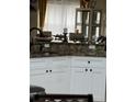 Kitchen island with granite countertops and white cabinetry at 4411 Hazelton Ct, Orlando, FL 32818