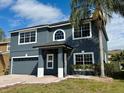 Charming two-story home with gray stucco exterior, gray roof, and attractive curb appeal at 5768 Los Palma Vista Dr, Orlando, FL 32837