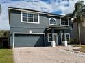 Charming two-story home with gray stucco exterior, gray roof, and attractive curb appeal at 5768 Los Palma Vista Dr, Orlando, FL 32837