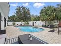 Backyard features a refreshing pool, brick patio, spa, and comfortable seating at 701 Denton Rd, Winter Park, FL 32792