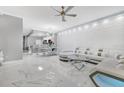 Spacious living room features a white sectional sofa, marble floors, and bar seating at 7159 Cadiz Blvd, Orlando, FL 32819