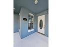 Close up of the blue covered front porch with a white front door at 7187 Wild Strawberry Run, Winter Garden, FL 34787