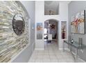 Inviting foyer featuring decorative stone wall, tiled floors, and elegant decor at 7952 Heritage Entrance Blvd, Kissimmee, FL 34747