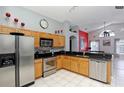 Spacious kitchen with wood cabinets, stainless steel appliances, and tiled floors at 7952 Heritage Entrance Blvd, Kissimmee, FL 34747