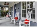 Comfortable front porch with rocking chairs, and white trim offering a relaxing outdoor space at 807 E Pine St, Orlando, FL 32801