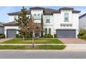 Beautiful two-story home with a gray roof, two-car garage, and well-maintained lawn at 8390 Ludington Cir, Orlando, FL 32836