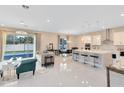 Bright, open-concept living space with a large island, modern finishes, and tile floors at 8390 Ludington Cir, Orlando, FL 32836