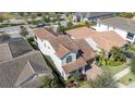 Aerial view of a home with a terracotta roof, palm trees, and colorful landscaping at 10209 Henbury St, Orlando, FL 32832