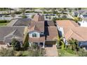 Aerial view of a home with a terracotta roof, palm trees, and colorful landscaping at 10209 Henbury St, Orlando, FL 32832