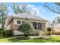 An exterior view of a house with lush landscaping and well-maintained lawn at 1203 Gatwick Loop, Lake Mary, FL 32746
