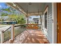 Stained wooden porch with a hanging swing and black railings at 125 E Grant St, Orlando, FL 32806