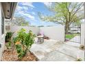 Private courtyard with stone tile, lush foliage, and seating area perfect for relaxing outdoors at 169 Fallwood St, Fern Park, FL 32730