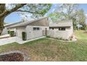View of the front of the home, featuring a quaint gated courtyard and neutral color scheme at 169 Fallwood St, Fern Park, FL 32730