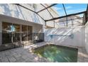 Private, screened-in pool area with a compact pool and tiled patio, ideal for relaxation at 17442 Hidden Forest Dr, Clermont, FL 34714