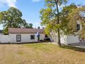 Inviting home with a manicured lawn and mature tree, complemented by a white fence for added privacy at 2531 Ludlow St, Deltona, FL 32738