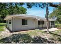 A single story home with a gray exterior, surrounded by green lawns and landscaping at 265 W Constance Rd, Debary, FL 32713