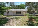 A charming single story house with a gray exterior, front yard and walkway to the door at 265 W Constance Rd, Debary, FL 32713