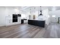 Modern kitchen features a large island and sleek, black appliances at 2650 Howard Ave, Oviedo, FL 32765