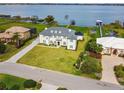 Stately waterfront home with manicured lawn, mature trees, and private dock, offering luxurious lakeside living and curb appeal at 30215 Island Club Dr, Deer Island, FL 32778