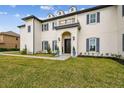 Elegant home entrance with a manicured lawn and walkway at 30215 Island Club Dr, Deer Island, FL 32778