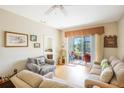 Comfortable living room with sliding glass doors opening to a serene outdoor view at 3632 Solana Cir # B, Clermont, FL 34711