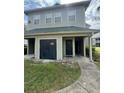 Exterior view of condo building with attached storage units and covered entries at 6100 Westgate Dr # 203, Orlando, FL 32835