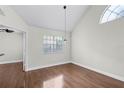 Open living room featuring high ceilings, a window, and laminate floors at 625 Greencove Ter # 130, Altamonte Springs, FL 32714