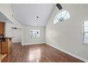 Bright living room featuring vaulted ceilings, a large window, and laminate floors at 625 Greencove Ter # 130, Altamonte Springs, FL 32714