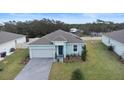 Drone shot of a single-Gathering home highlighting the manicured lawn, two-car garage, and the home's layout at 663 Fairview Ave, Haines City, FL 33844