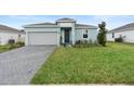 Charming single-Gathering home with a neatly maintained lawn, brick paved driveway, and welcoming curb appeal at 663 Fairview Ave, Haines City, FL 33844