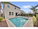 Relaxing backyard featuring a private pool, lounge chairs, and outdoor seating area at 7419 Marker Ave, Kissimmee, FL 34747
