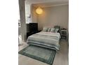 Cozy bedroom featuring a comfortable bed with decorative pillows and a nightstand with a lamp at 860 N Orange Ave # 470, Orlando, FL 32801