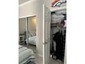 Bedroom closet with mirrored sliding door and an open door revealing plenty of storage space at 860 N Orange Ave # 470, Orlando, FL 32801