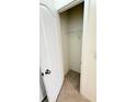 Walk-in closet with standard white wire shelving and tile flooring at 1003 Cascade Dr, Davenport, FL 33837