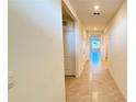 Hallway with tile flooring leads to the bedrooms and living areas at 1003 Cascade Dr, Davenport, FL 33837