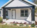 Home exterior showcasing a bright white exterior with black trim accents at 1112 W Line St, Leesburg, FL 34748