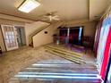 Open-concept living room with staircase, bar area, tile flooring, and large windows, perfect for entertaining at 11290 Se 189Th Ct, Ocklawaha, FL 32179