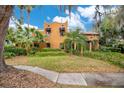 Spanish-style home with mature palm trees and lush landscaping at 1141 S Osceola Ave, Orlando, FL 32806