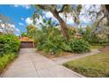 Attached two-car garage with brick driveway surrounded by mature landscaping at 1141 S Osceola Ave, Orlando, FL 32806