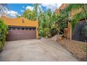 Spacious two-car garage and stairs leading to the house, surrounded by plants at 1141 S Osceola Ave, Orlando, FL 32806