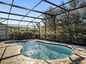 A private screened-in pool with brick pavers offers a relaxing backyard retreat at 16310 Rock Coast Dr, Winter Garden, FL 34787