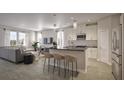 Open-concept kitchen and living room with a large island, stainless steel appliances, and sleek countertops at 167 Aulin Ave, Oviedo, FL 32765