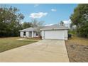 Charming single Gathering home featuring well-maintained landscaping and a two-car garage at 25 Maple Crse, Ocklawaha, FL 32179