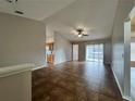 Spacious living room featuring tile flooring, sliding glass doors, and a ceiling fan at 324 Anchovie Ct, Kissimmee, FL 34759