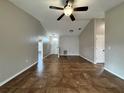 Open living room features neutral walls, tile flooring, and ample natural light at 324 Anchovie Ct, Kissimmee, FL 34759