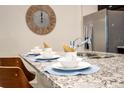 Close-up of kitchen island, featuring granite countertops and ample space for food preparation at 3432 Lilac Way, Davenport, FL 33897