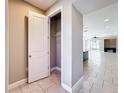 Hallway featuring tile floors and a view into the kitchen and living area at 363 Buchannan Drive, Davenport, FL 33837